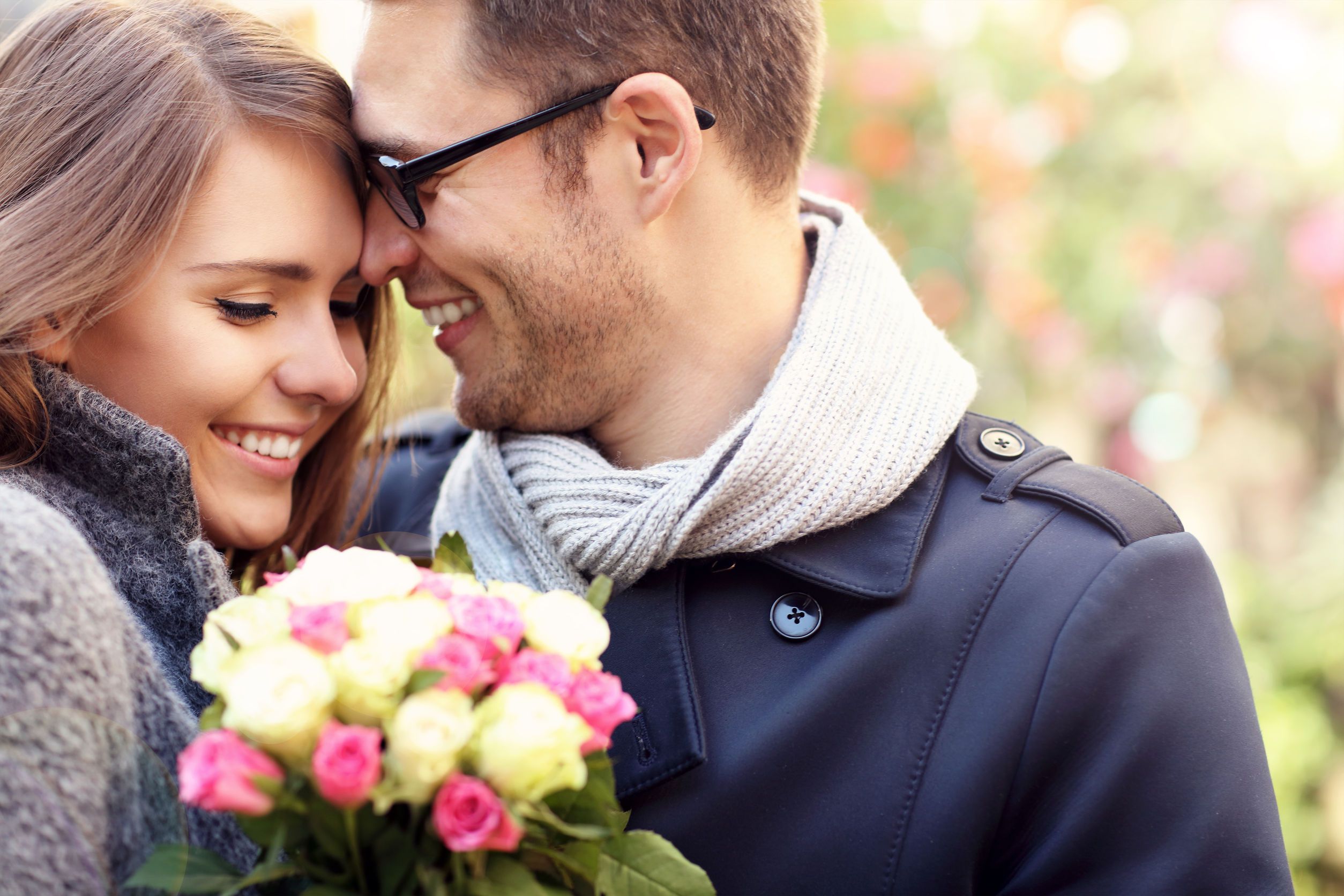 picture showing happy couple hugging with flowers in the city